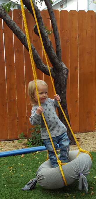 Lucy swinging in her backyard