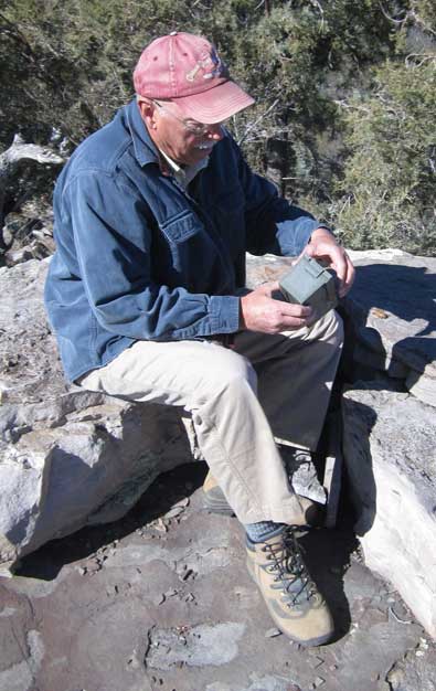 Ralph finds the cache "at the top", note the petroglyphs on the enlargement.