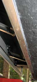 Aluminum bottom panel wraps under the trailer