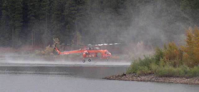 An Erickson Air Crane picks up water from the lake