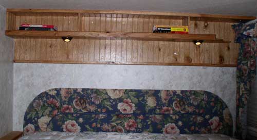 The finished RV bedroom shelf with reading lamps