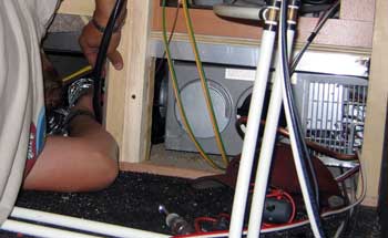 Crawling behind the furnace to gain access to the high limit sensor