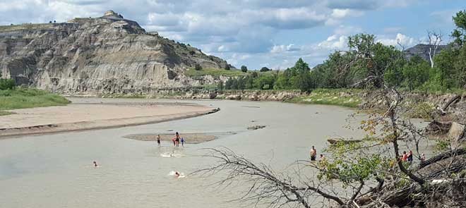 The kids love swimming in the muddy Little Missouri River