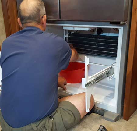 Working on a refrigerator repair