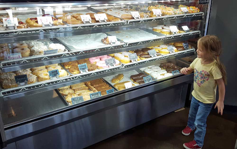 Lucy picking out a vegan donut