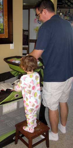 Chloe pulls her stool over to help Dad with Noah