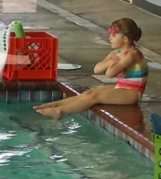 Chloe waiting for her swim lesson, Behind: The lesson begins