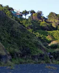 We've been seeing this house for five miles, Behind: Black Sands Beach, the end of our journey
