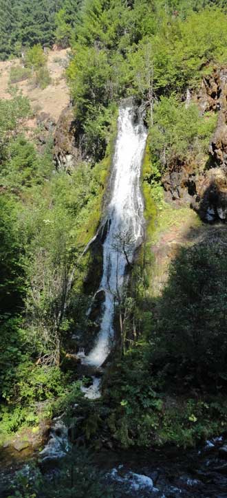 A waterfall across the North Umpqua, behind: a wet trail too