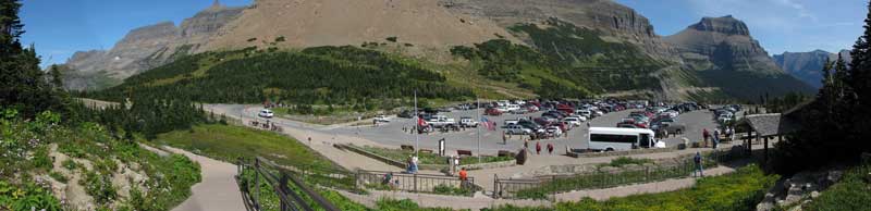 The Logan Pass parking lot is full. The visitor center is to the right. 