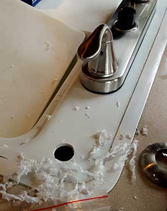 Drilling into the fiberglass sink for a spray hose