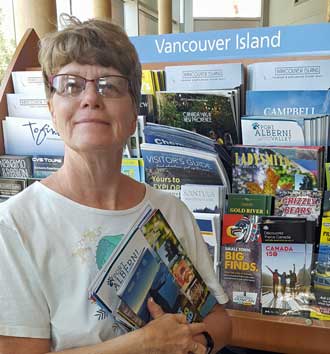 Gwen is pickup up free brochures at the BC visitor center