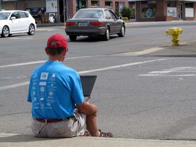 Sitting on a curb in Yuba City, California uploading a video to YouTube